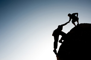 helping hand for climber ascending to ledge